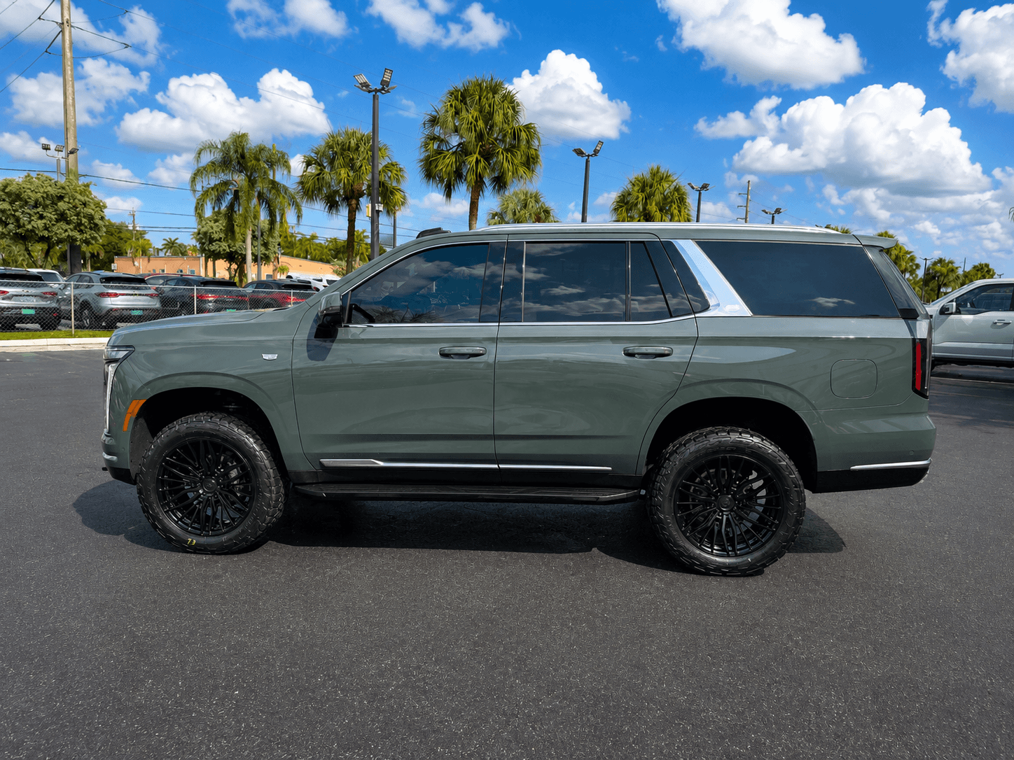 Customer Cadillac Escalade professionally lifted by HGreg Lifted on black wheels and all-terrain tires