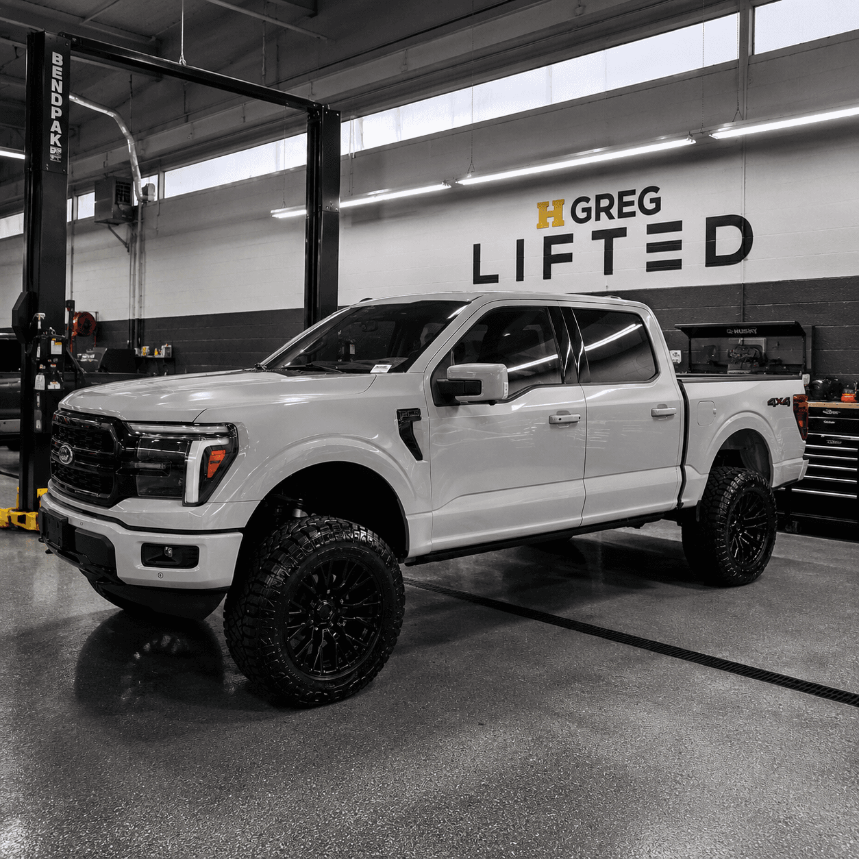 Lifted white Ford F-150 in the HGreg Lifted build bay