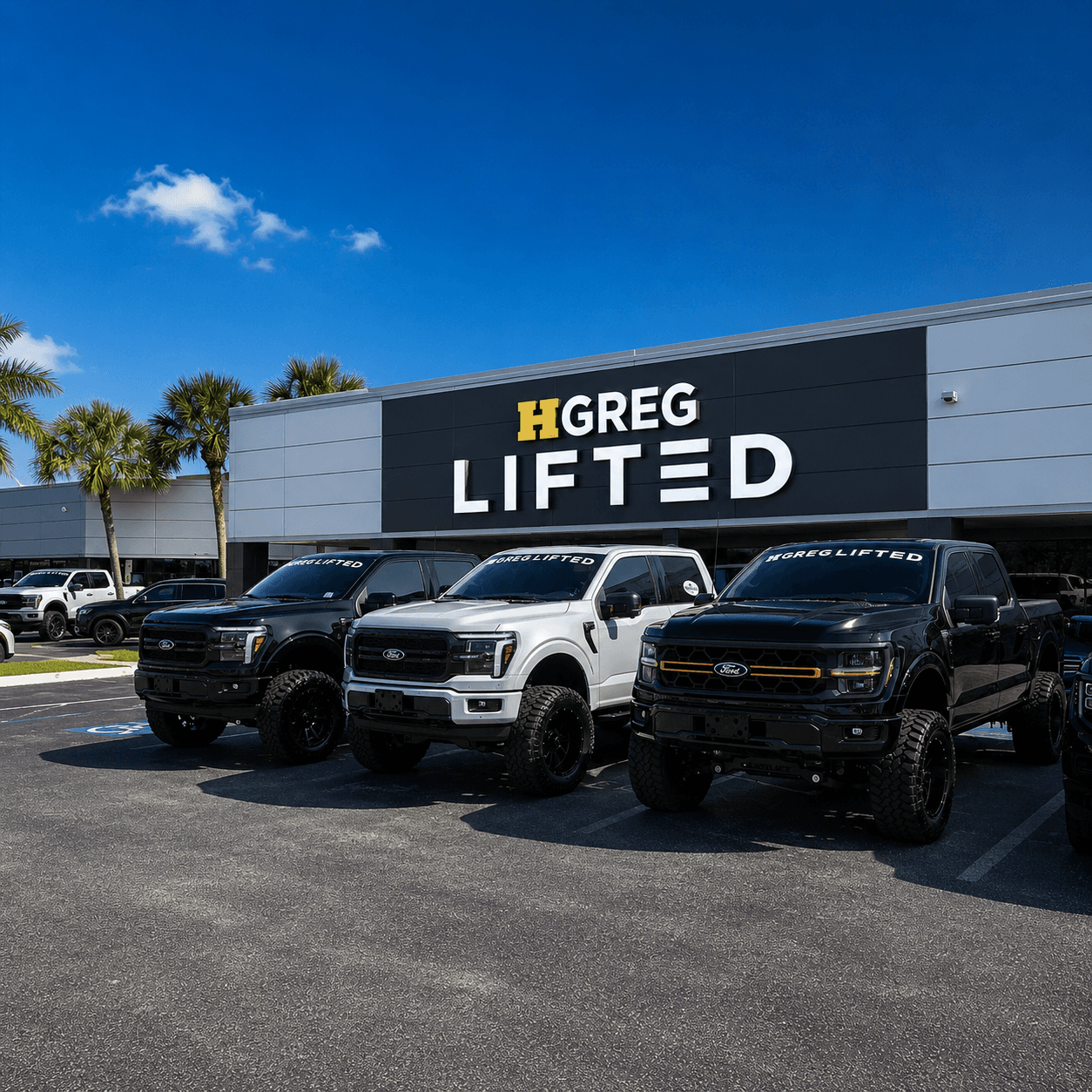 Completed HGreg Lifted truck builds lined up outside the shop